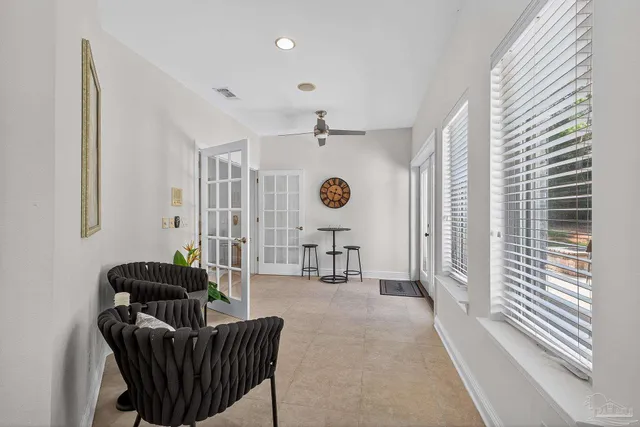 a kitchen with stainless steel appliances granite countertop a stove top oven a sink a dining table and chairs with wooden floor