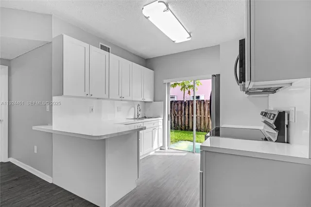a kitchen with a sink and a refrigerator