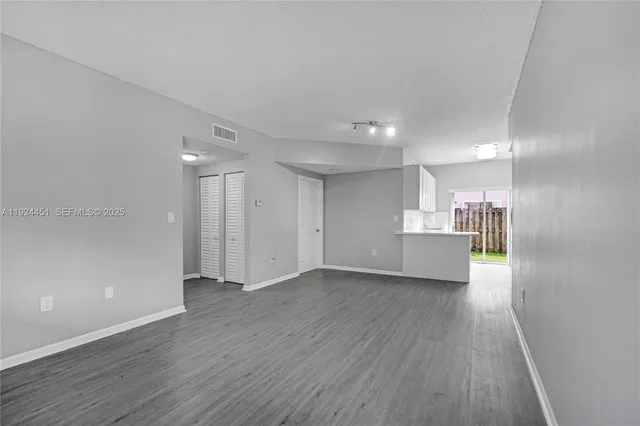 a view of a kitchen with wooden floor