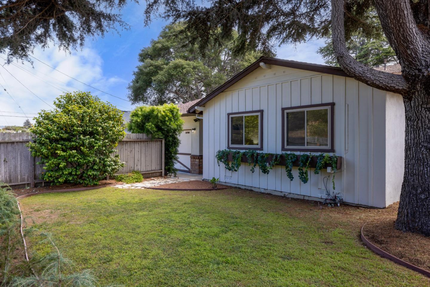 3370 Rio Road Carmel, CA 93923 - Photo 2 of 15 a backyard of a house with yard and outdoor seating