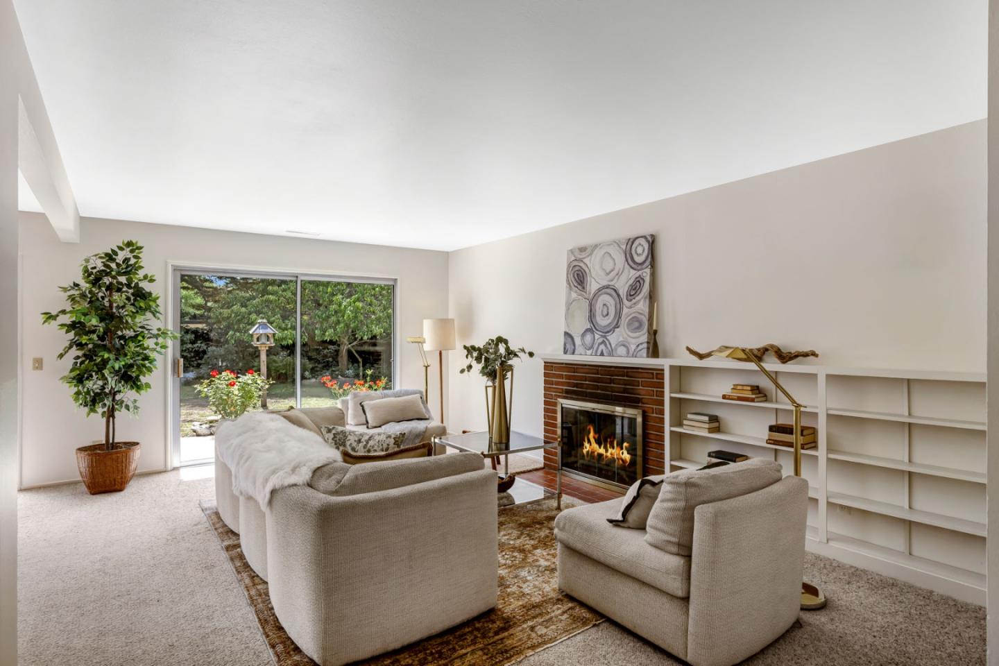 3370 Rio Road Carmel, CA 93923 - Photo 3 of 15 a living room with furniture a fireplace and potted plants