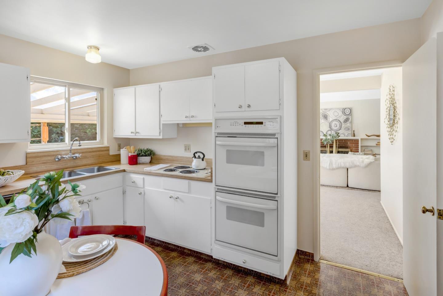 3370 Rio Road Carmel, CA 93923 - Photo 6 of 15 a kitchen with stainless steel appliances white cabinets and a window