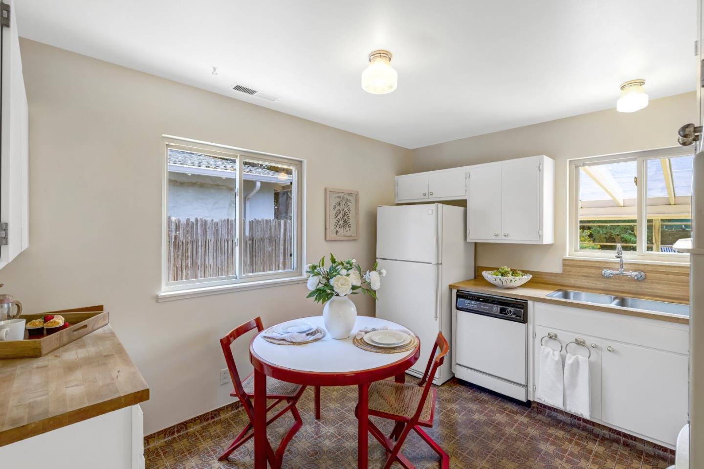 3370 Rio Road Carmel, CA 93923 - Photo 7 of 15 a kitchen with stainless steel appliances kitchen island granite countertop a sink a stove a dining table and chairs