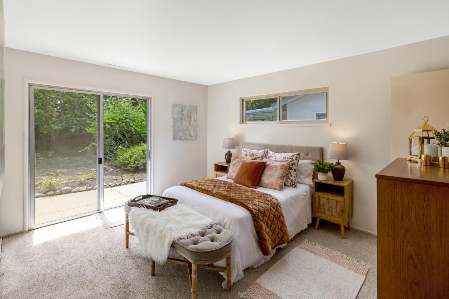 3370 Rio Road Carmel, CA 93923 - Photo 8 of 15 a bedroom with a bed and a dresser next to a window