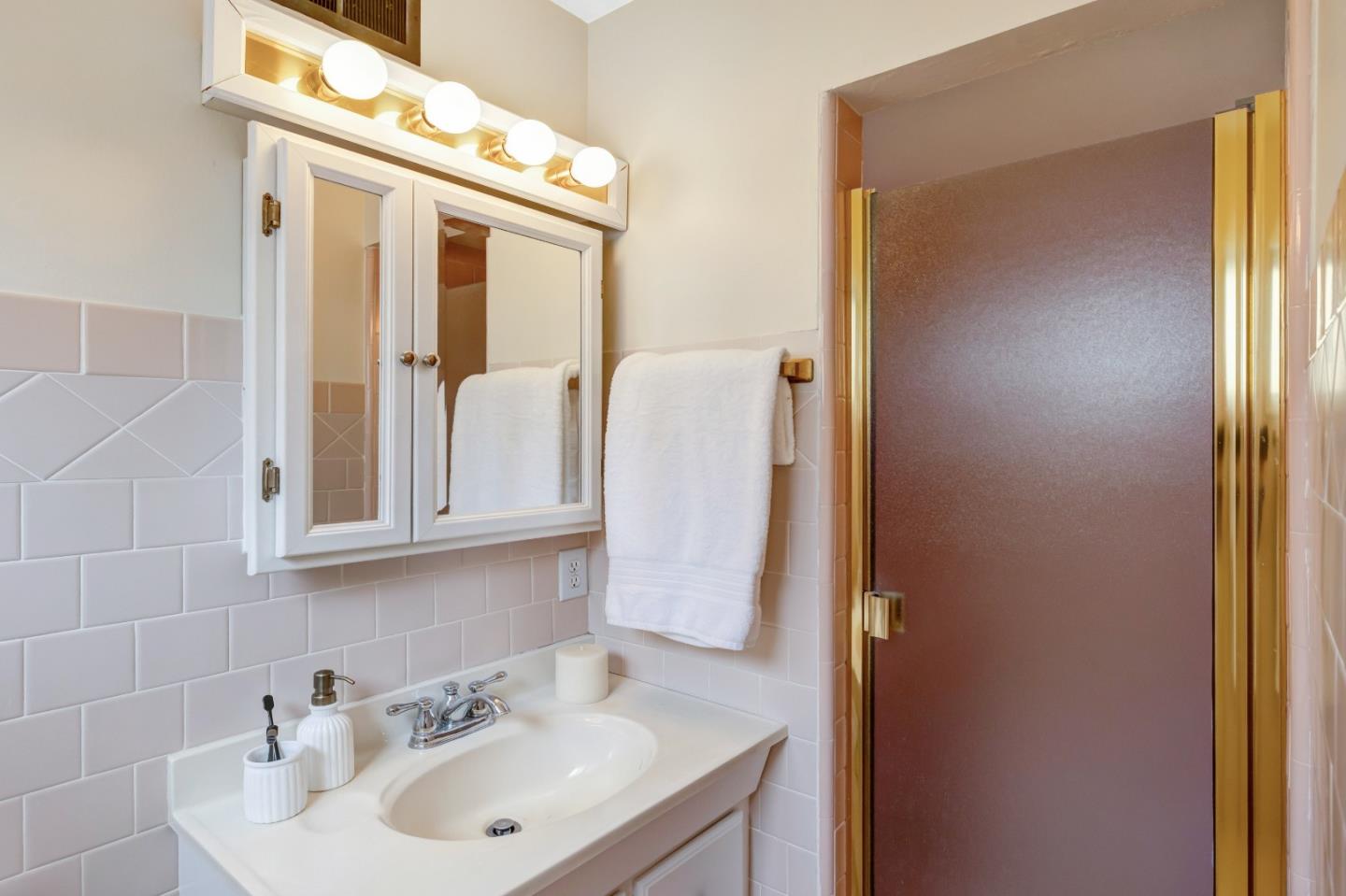 3370 Rio Road Carmel, CA 93923 - Photo 10 of 15 a bathroom with a sink and a mirror