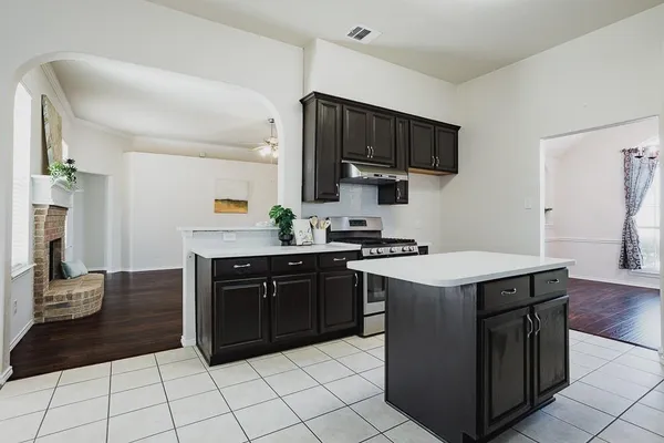 a kitchen with a sink and a stove top oven