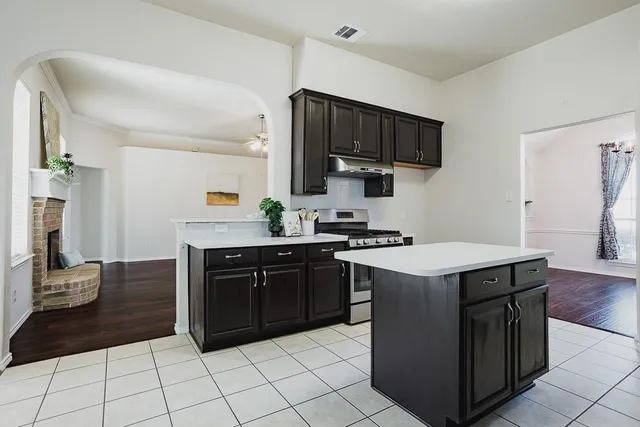 a kitchen with a sink and a stove top oven