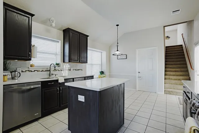 a kitchen with a sink appliances and cabinets