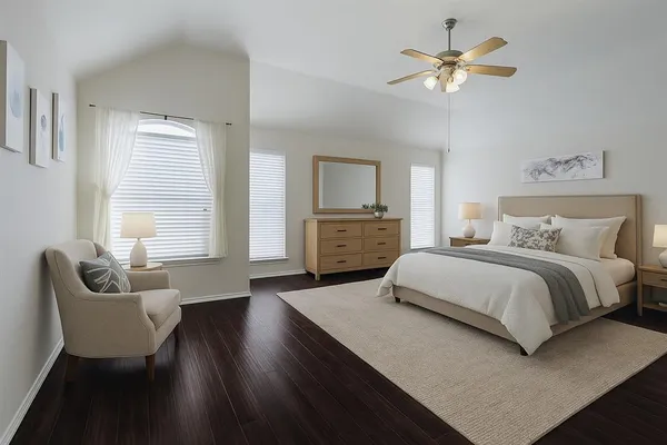 a bedroom with a large bed a chandelier and a couch