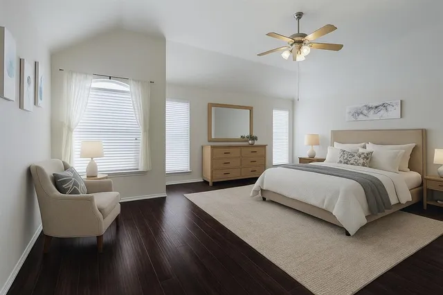 a bedroom with a large bed a chandelier and a couch