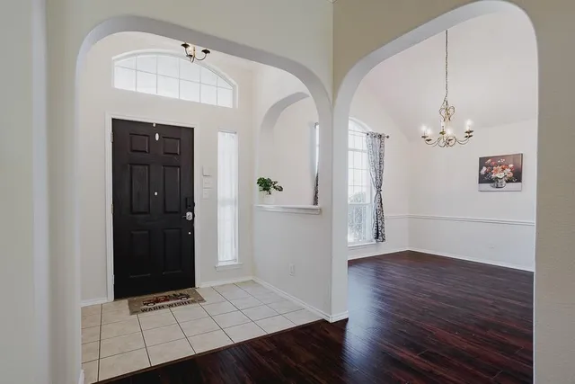a view of an entryway with wooden floor
