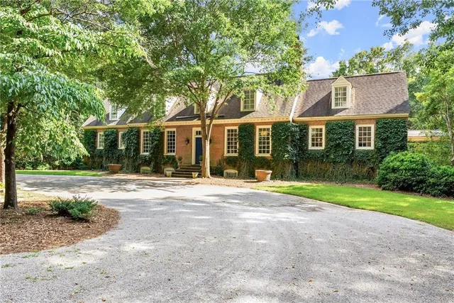 a view of a house with a yard and plants
