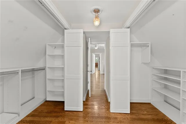 a bathroom with a granite countertop sink a mirror and shower