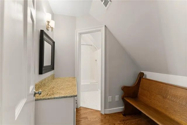 a view of a bedroom with wooden floor and stairs