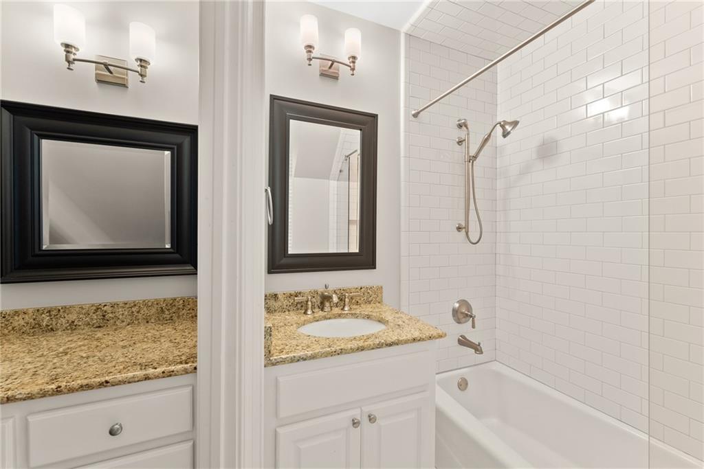 1885 Lake Warner Road Gainesville, GA 30501 - Photo 30 of 67 a bathroom with a granite countertop sink a mirror and shower