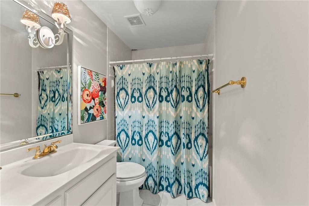 1885 Lake Warner Road Gainesville, GA 30501 - Photo 34 of 67 a bathroom with a sink toilet and shower curtain