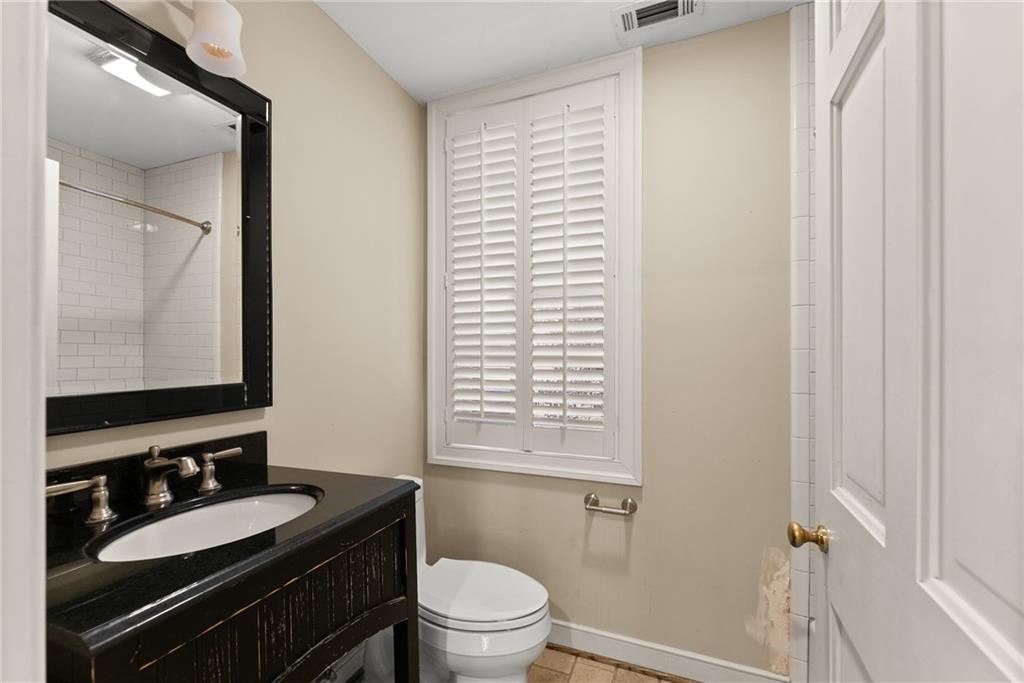 1885 Lake Warner Road Gainesville, GA 30501 - Photo 37 of 67 a bathroom with a granite countertop sink toilet a mirror and shower
