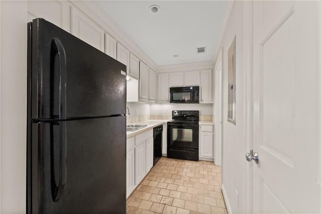 1885 Lake Warner Road Gainesville, GA 30501 - Photo 40 of 67 a kitchen with a refrigerator and a stove top oven
