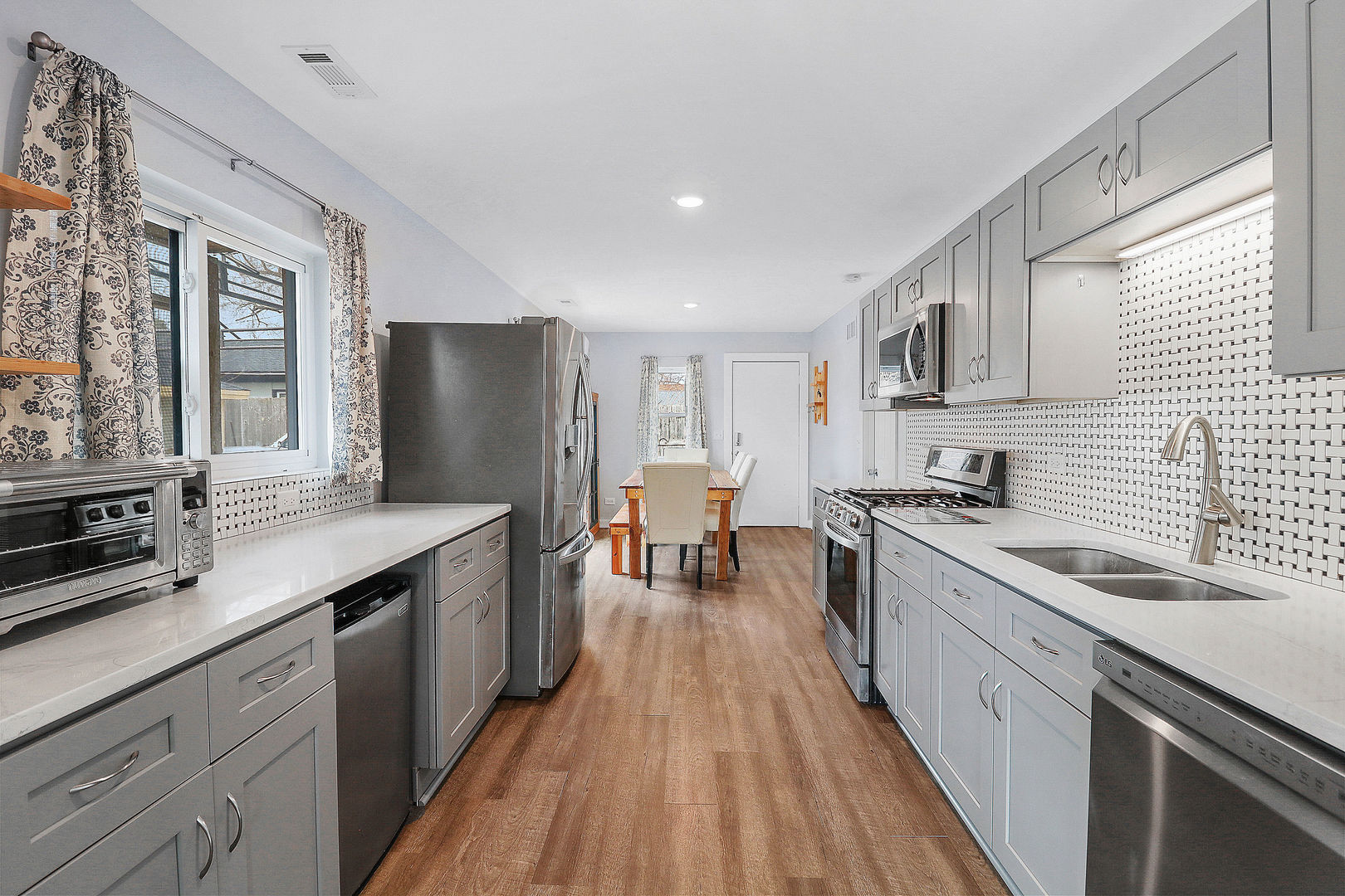 502 Monroe Avenue Ingleside, IL 60041 - Photo 5 of 20 a kitchen with stainless steel appliances granite countertop sink stove top oven and cabinets