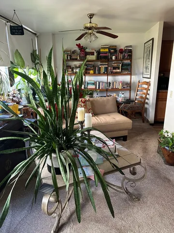 a living room with furniture and painting on the wall