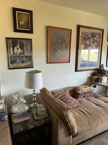 a bedroom with bed and painting on the wall