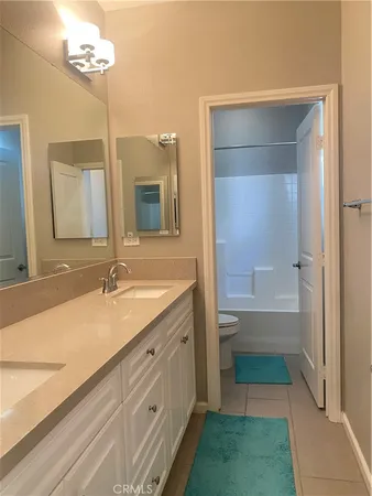 a bathroom with a double vanity sink and a mirror