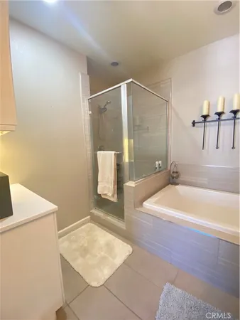 a bathroom with a tub a sink and a shower