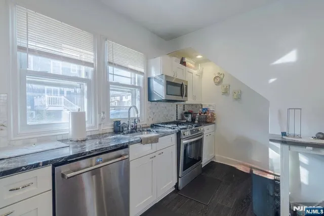 a kitchen with a refrigerator and a stove