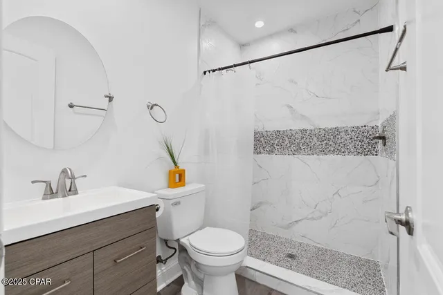 a bathroom with a shower and a glass door