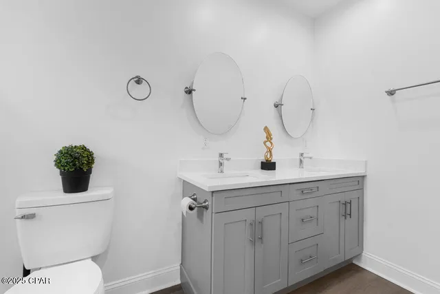 a front view of house with yard and trees in the background