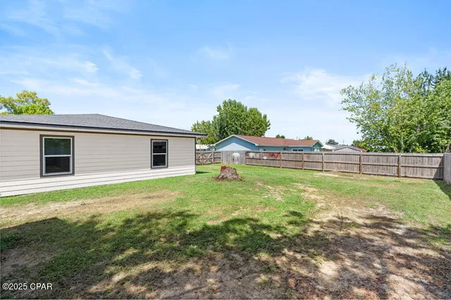 aerial view of a house with a yard