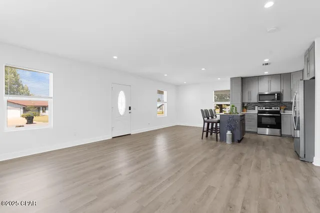 a view of workspace with wooden floor windows and cabinet