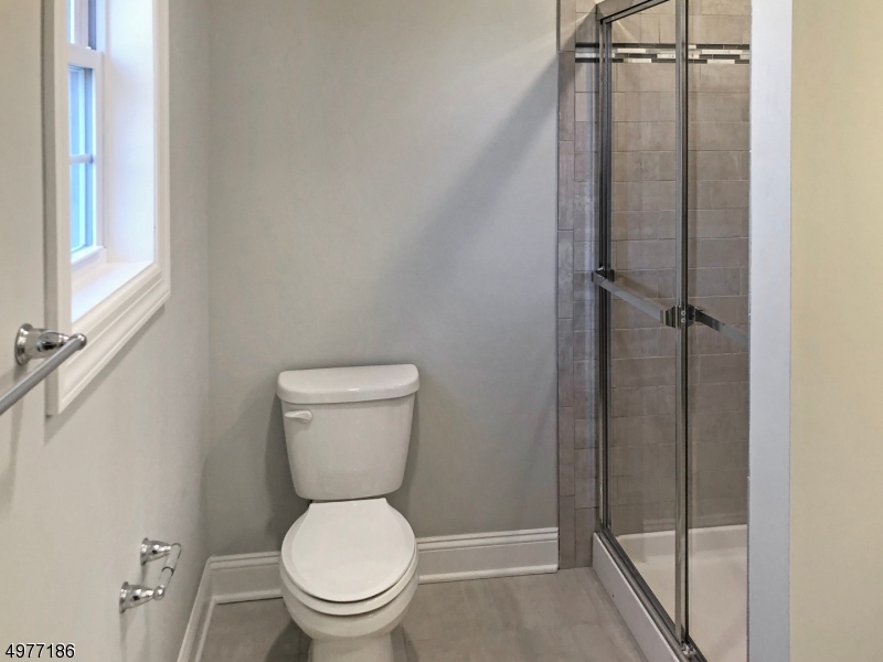 38 Old Shunpike Road, Unit B Randolph, NJ 07869 - Photo 12 of 18 a white toilet sitting next to a shower