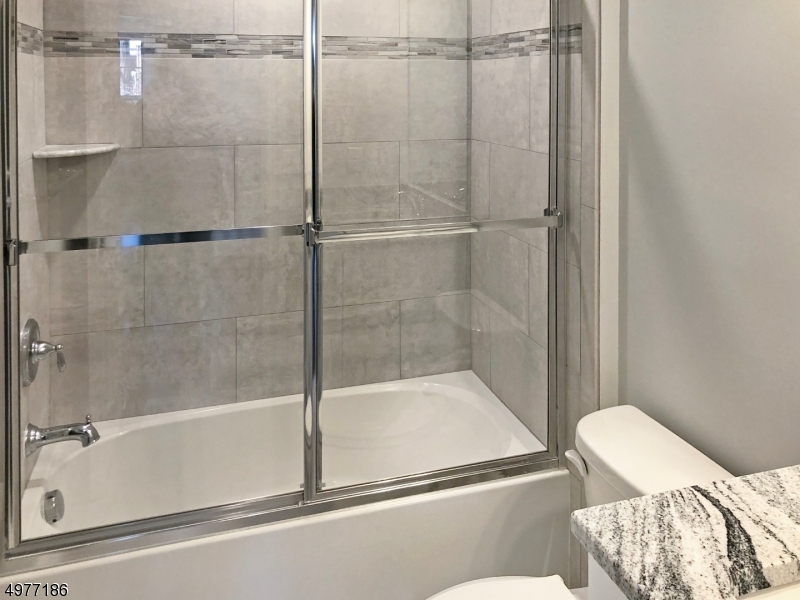 38 Old Shunpike Road, Unit B Randolph, NJ 07869 - Photo 17 of 18 a bathroom with a bathtub and a shower