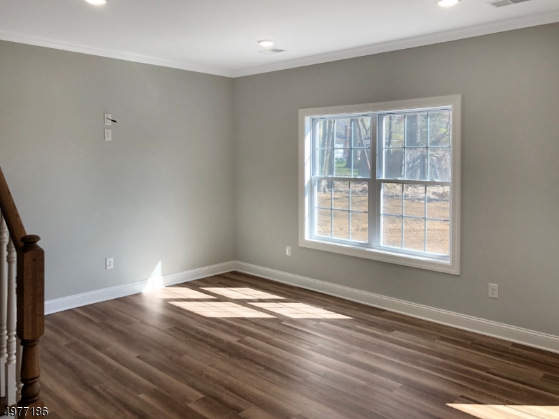 38 Old Shunpike Road, Unit B Randolph, NJ 07869 - Photo 6 of 18 a view of an empty room with wooden floor and a window