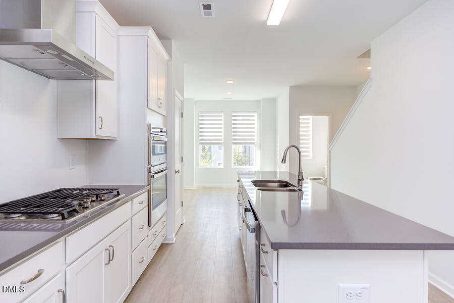 1949 Robin Hill Lane Raleigh, NC 27610 - Photo 11 of 39 a kitchen with sink a stove and cabinets