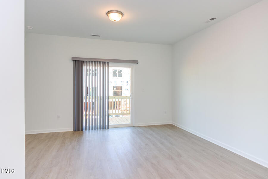 1949 Robin Hill Lane Raleigh, NC 27610 - Photo 12 of 39 an empty room with wooden floor and windows