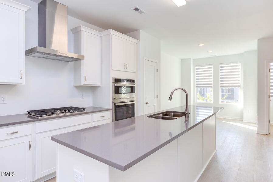 1949 Robin Hill Lane Raleigh, NC 27610 - Photo 17 of 39 a kitchen with white cabinets and appliances