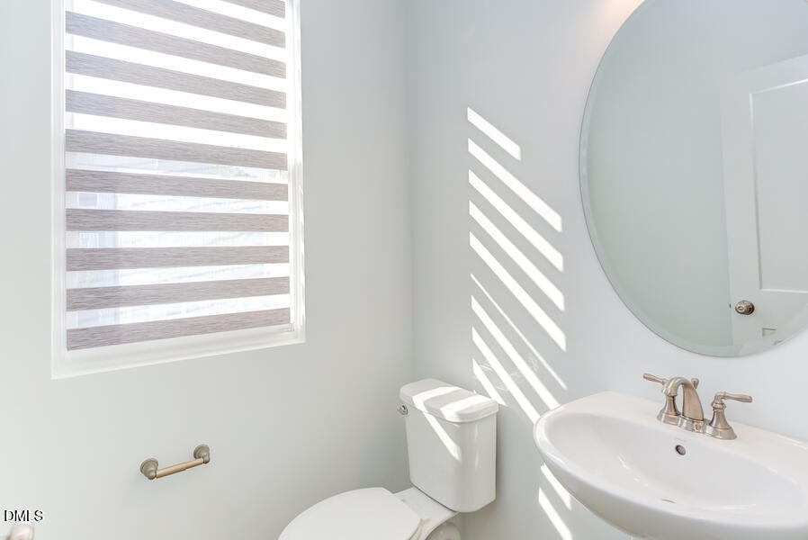 1949 Robin Hill Lane Raleigh, NC 27610 - Photo 21 of 39 a bathroom with a sink and mirror with toilet