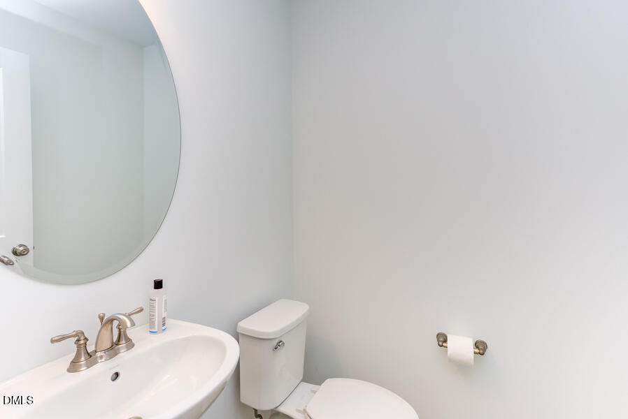 1949 Robin Hill Lane Raleigh, NC 27610 - Photo 9 of 39 a bathroom with a sink mirror and toilet