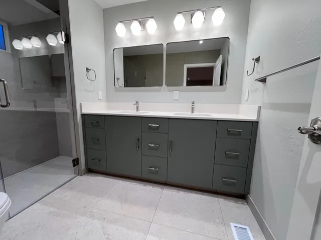 a bathroom with a double sink sink and mirror