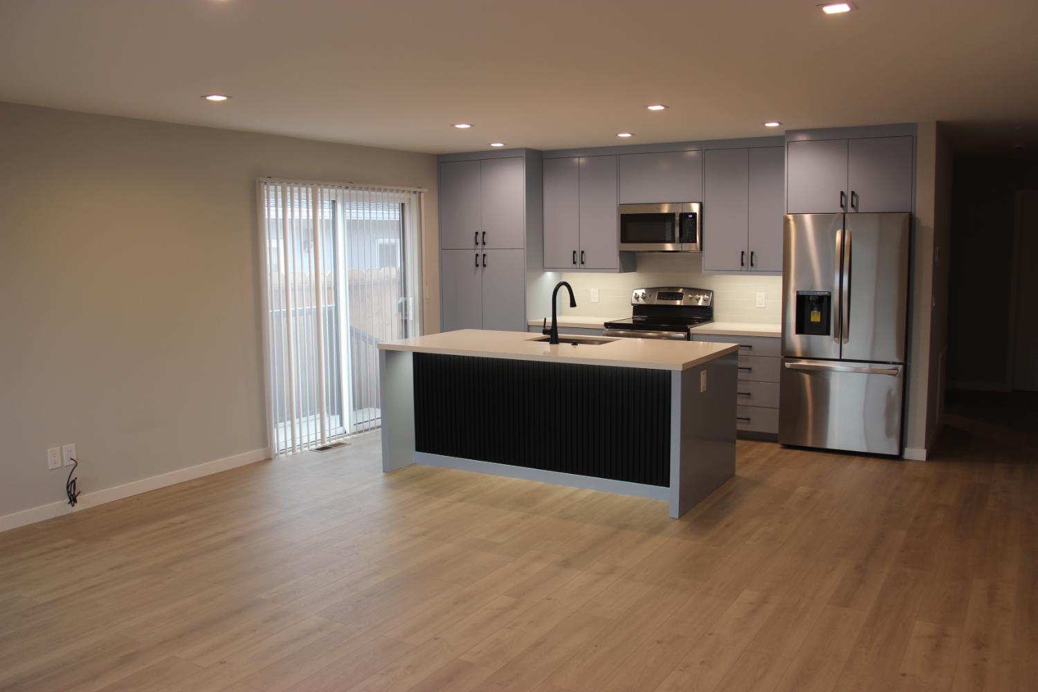 355 Sonoma Avenue Seaside, CA 93955 - Photo 32 of 32 a kitchen with kitchen island stainless steel appliances a stove refrigerator sink and microwave