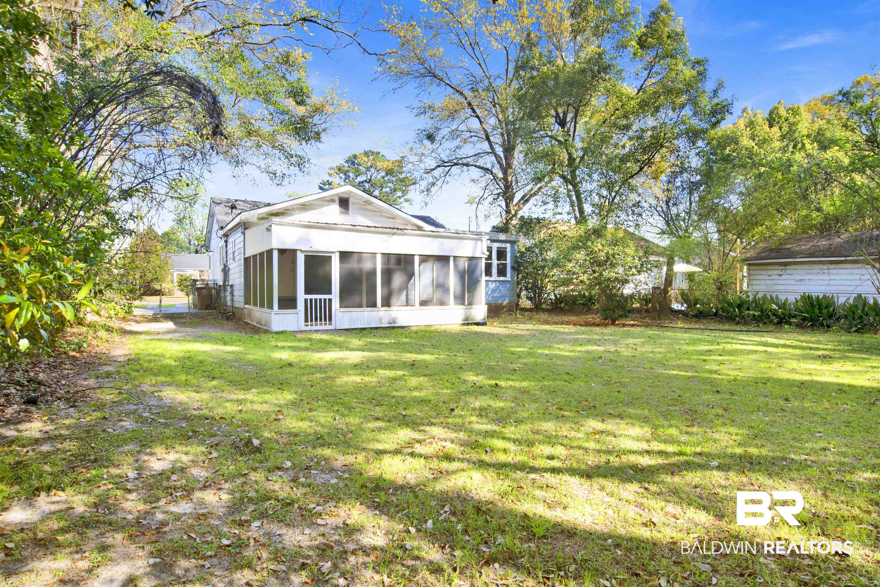 160 Emogene Place Mobile, AL 36606 - Photo 29 of 32 Rear view of house with a yard and a sunroom
