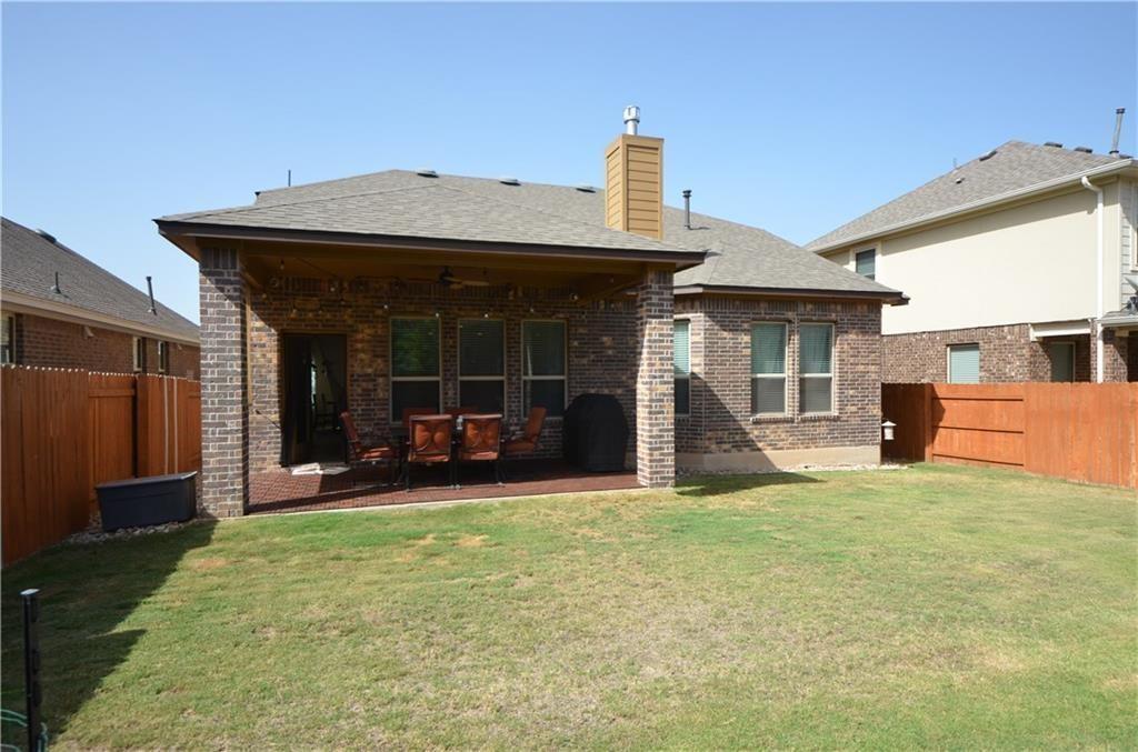 5629 Rio Chama Cove Austin, TX 78738 - Photo 24 of 34 An inviting backyard with a covered patio offers ample space for outdoor enjoyment and entertaining.