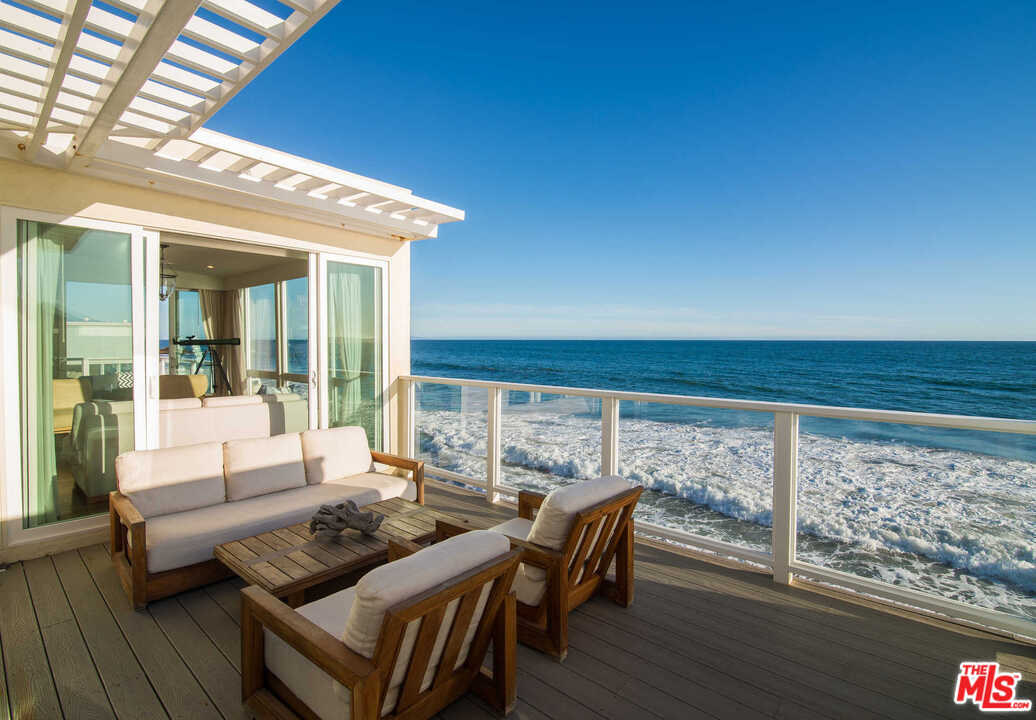 25152 Malibu Road Malibu, CA 90265 - Photo 1 of 1 a roof deck with table and chairs
