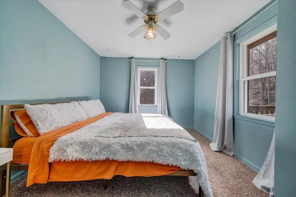 a bedroom with a large bed and a chandelier