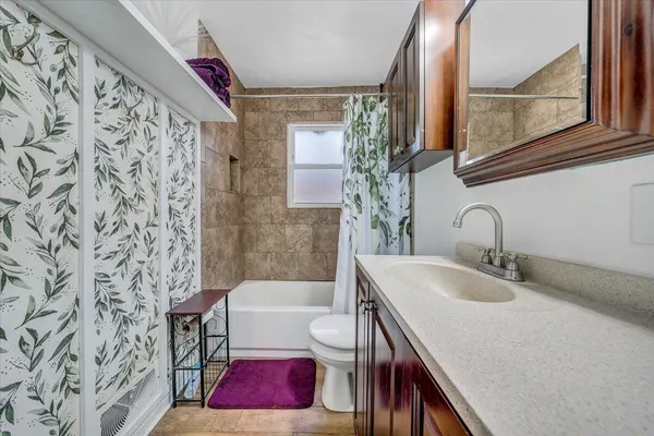 a bathroom with a sink toilet and shower