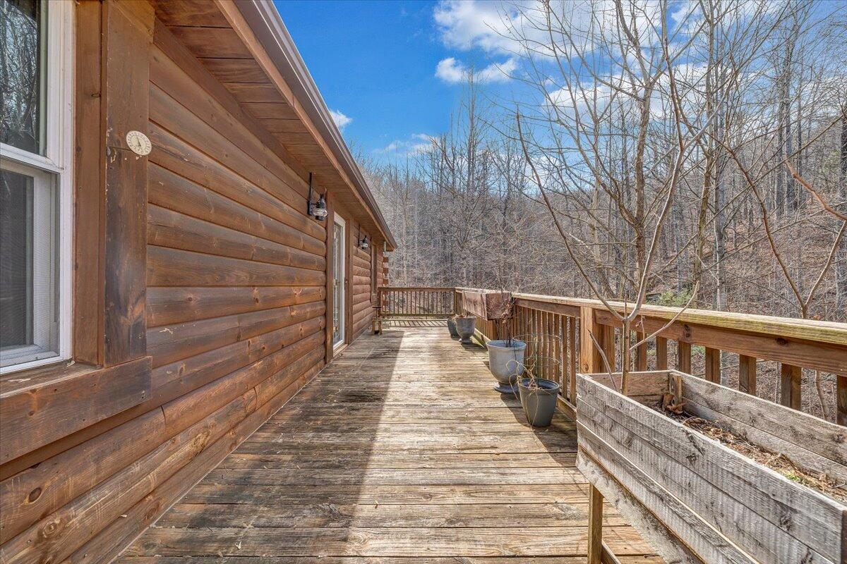 6847 Crowell Gap Road Boones Mill, VA 24065 - Photo 20 of 55 a view of balcony with wooden floor and fence and a potted plant
