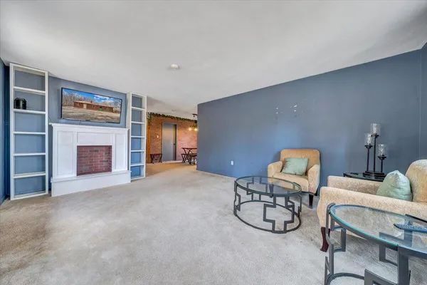 a view of work space with furniture and fireplace