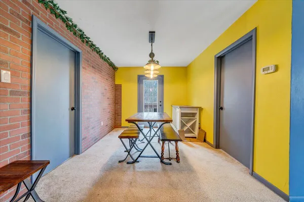 a view of a dining room with furniture and chandelier